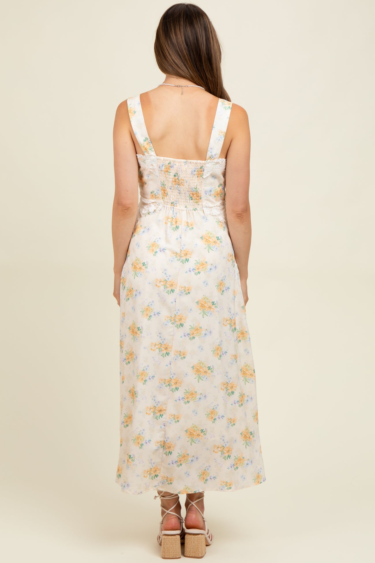 woman wearing a floral print maternity maxi dress with a smocked back, showcasing a comfortable fit