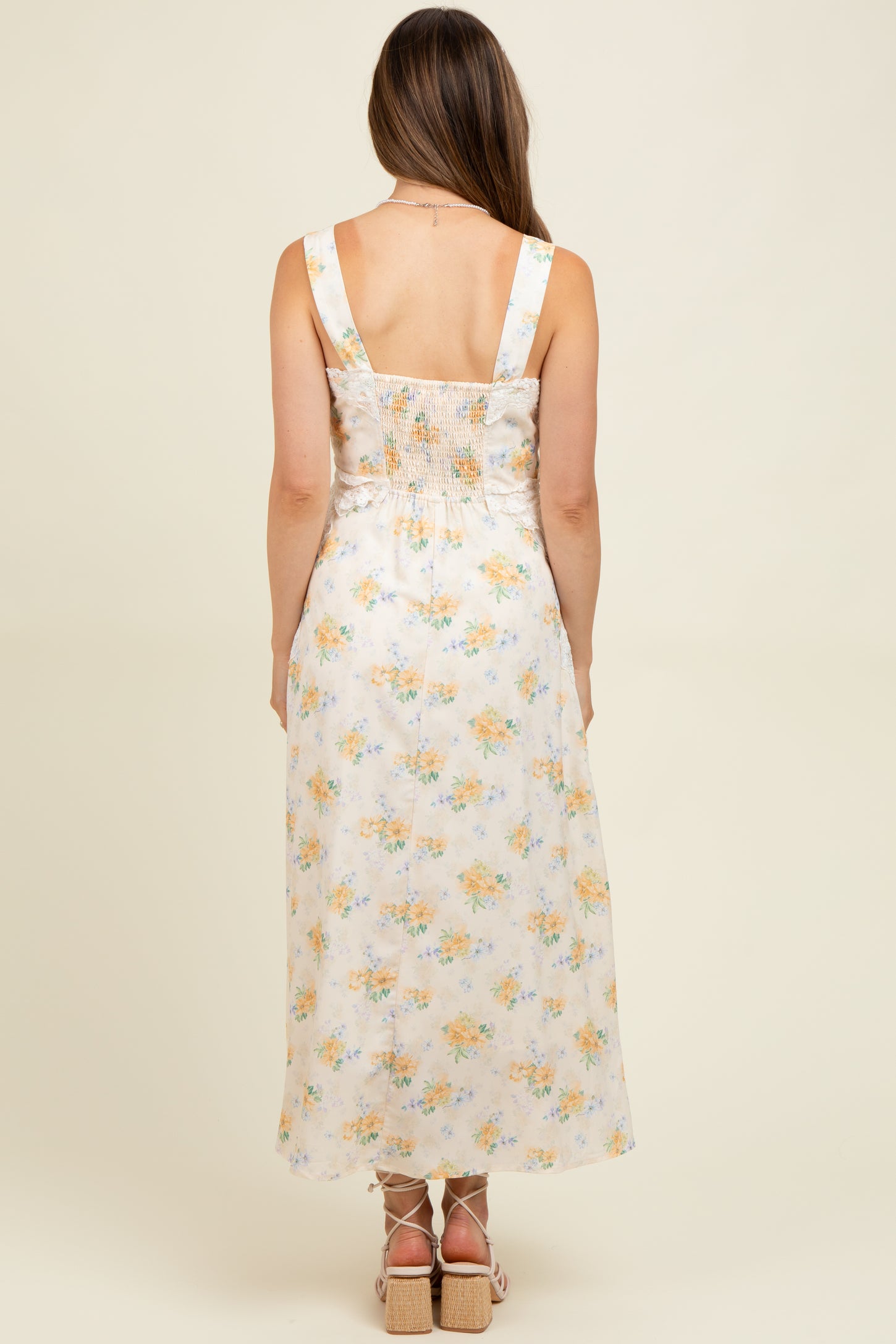 woman wearing a floral print maternity maxi dress with a smocked back, showcasing a comfortable fit