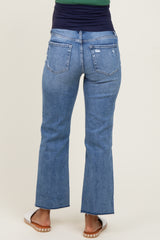 woman wearing a pair of medium wash maternity flare jeans shown from the back, featuring distressed details and a cropped hem