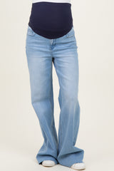 woman wearing light blue maternity flared jeans with a dark blue stretchy waistband
