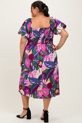 woman wearing a colorful floral print plus size dress with puffed sleeves, shown from the back