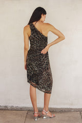 woman wearing a one-shoulder leopard print dress with a fitted silhouette and asymmetric hemline