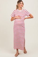 woman wearing a white and red striped maternity maxi dress with short sleeves and a side slit, holding her baby bump