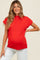 woman wearing a bright red maternity top with short sleeves and a baby bump visible