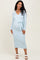 woman wearing a light blue long sleeve maternity dress with a tie waist and visible baby bump