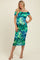 woman wearing a colorful off-the-shoulder maternity dress that highlights her baby bump