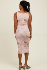 woman wearing a light pink form-fitting midi dress with floral print and a scoop back