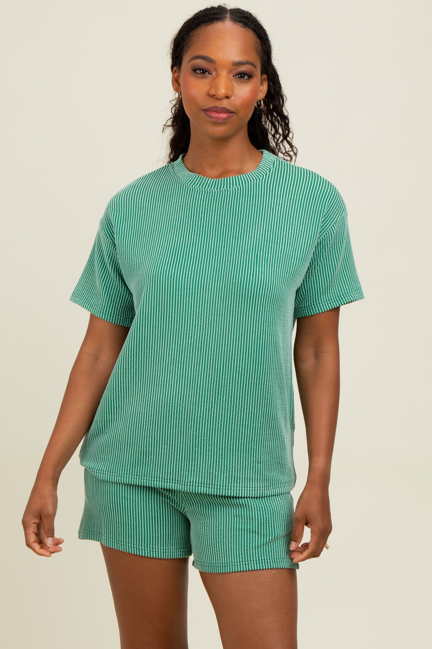 woman wearing a green striped matching short sleeve top and shorts set