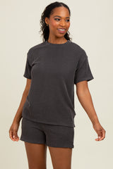 woman wearing a black and white striped short sleeve loungewear set with a relaxed fit and matching shorts
