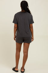 woman wearing a black striped short sleeve top and matching shorts, viewed from the back