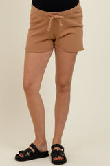 woman wearing khaki maternity shorts with drawstring waist and side pockets