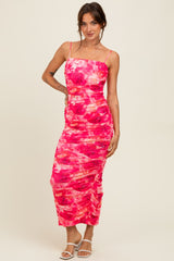 woman wearing a pink and red floral print bodycon midi dress with ruching and spaghetti straps