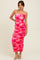 woman wearing a pink and red floral print bodycon midi dress with ruching and spaghetti straps
