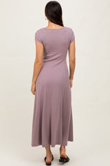 woman wearing a mauve short sleeve maxi dress, shown from the back, with a flowy skirt and fitted bodice