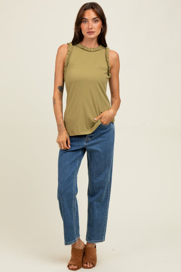 woman wearing an olive green sleeveless top with ruffle details and blue high-waisted straight-leg jeans