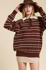 woman wearing a brown striped oversized sweater with a white collar and a beige mini skirt, paired with a brown hat