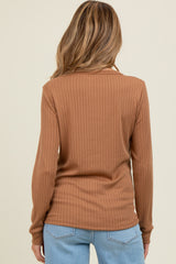 woman wearing a brown ribbed long sleeve maternity top, seen from the back