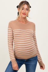 woman wearing a tan striped maternity sweater with a round neckline and long sleeves, showcasing her baby bump