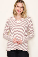woman wearing a cream and burgundy striped long sleeve v-neck top with relaxed fit and soft fabric