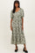 woman wearing a floral green midi dress with puff sleeves and a relaxed fit