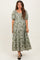 woman wearing a green floral print maternity maxi dress with puff sleeves and a v-neckline