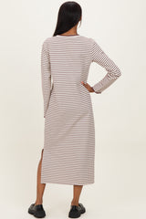 woman wearing a striped long sleeve midi dress with side slits, viewed from the back