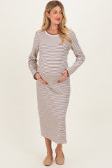 woman wearing a striped maternity dress, holding her baby bump, with long sleeves and a midi length