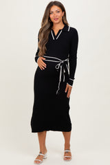 woman wearing a black ribbed maternity dress with a white collar and tie detail, showcasing her baby bump