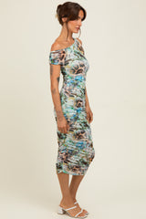 woman wearing a multi-colored off-shoulder midi dress with ruching details and a fitted silhouette