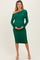 woman wearing a green one-shoulder ruched maternity dress and holding her baby bump