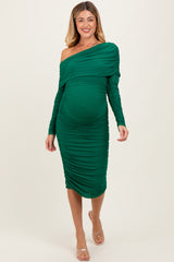 woman wearing a green off-shoulder maternity dress with ruching and a visible baby bump
