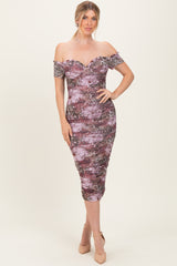 woman wearing a purple and pink off-shoulder floral bodycon dress with ruched detailing and a midi length