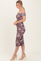 woman wearing a purple off-the-shoulder bodycon dress with ruched detailing and a midi length