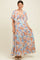 woman wearing a light blue floral maternity maxi dress with a tie-front detail and flutter sleeves, showcasing her baby bump
