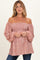 woman wearing a rust off-the-shoulder maternity top with puff sleeves and floral print