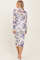 woman wearing a long sleeve bodycon dress with purple floral print and a midi length, shown from the back