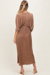 woman wearing a brown ribbed maternity dress with a belted waist and a flowing silhouette