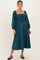woman wearing a teal maternity midi dress with puff sleeves and a smocked bodice, holding her baby bump
