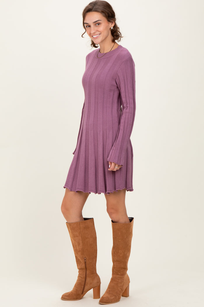 woman wearing a long sleeve ribbed lavender dress with flared hem and tan knee-high boots