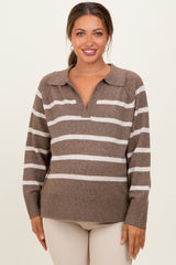 woman wearing a brown and cream striped maternity sweater with a collar and v-neckline