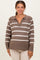 woman wearing a brown and cream striped maternity sweater with a collar and v-neckline