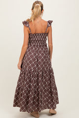 woman wearing a brown floral maternity maxi dress with ruffled straps and a smocked bodice, showing her back
