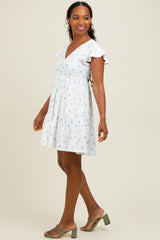 woman wearing a white floral print short sleeve dress with a flared skirt and v-neckline