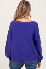 woman wearing a purple oversized maternity sweater with a relaxed fit, seen from the back