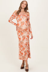woman wearing a floral off-the-shoulder maternity dress with long sleeves and a visible baby bump
