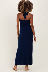 woman wearing a navy blue strapless maternity maxi dress with a halter neck and gathering details in the back