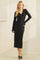 woman wearing a black long sleeve ribbed midi dress with a button-down front and a v-neckline