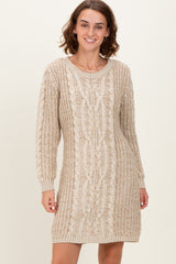 woman wearing a beige cable knit sweater dress with long sleeves and a relaxed fit