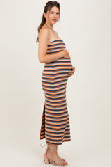 woman wearing a striped maternity maxi dress with a fitted silhouette and a side slit, showcasing her baby bump