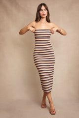 woman wearing a strapless striped midi dress with a fitted silhouette and a neutral color palette